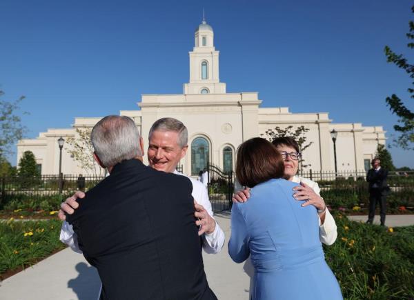 Elder David A. Bednar and his wife, Sister Susan Bednar, greet church members outside the Bentonville Arkansas Temple.