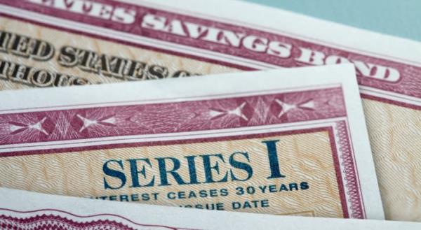 Several Series I Savings Bonds or "ibonds" stacked on top of each other. 