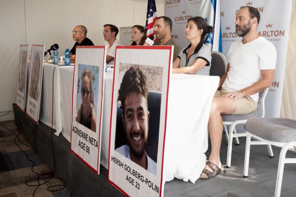 Seated from left: Jonathan Dekel-Chen, father of Sagui Dekel-Chen from Nahal Oz; Ruby Chen, father of Itay Chen, 19, a soldier in the armored corps; Ayala Neta, daughter, and Nahal Neta, son of Adrienne Neta, 66, a nurse living in Kibbitz Be'eri; Rachel Goldberg, mother of Hersh Goldberg-Polin, 23, who was attending the music festival, and Jonathan Polin, Hersh's father. (Maya Alleruzzo / AP)