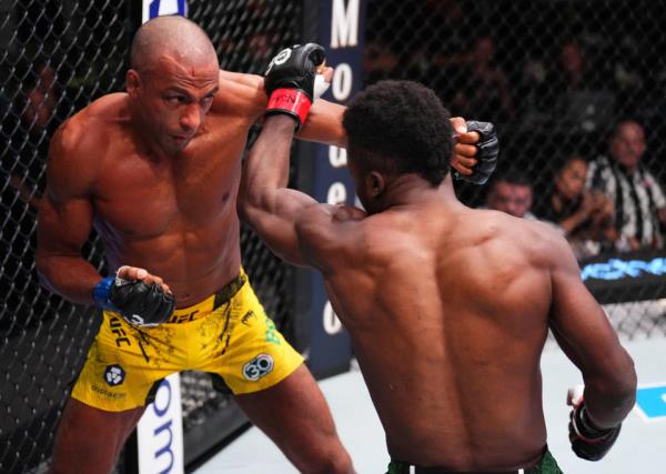 LAS VEGAS, NEVADA – OCTOBER 14: (L-R) Edson Barboza of </em>ink " href="https://sports.yahoo.com/soccer/teams/brazil-women/" data-i13n="sec:content-canvas;subsec:anchor_text;elm:context_link" data-ylk="slk:Brazil;sec:content-canvas;subsec:anchor_text;elm:context_link;itc:0">Brazil and Sodiq Yusuff of </em>ink " href="https://sports.yahoo.com/soccer/teams/nigeria-women/" data-i13n="sec:content-canvas;subsec:anchor_text;elm:context_link" data-ylk="slk:Nigeria;sec:content-canvas;subsec:anchor_text;elm:context_link;itc:0">Nigeria trade punches in a featherweight fight during the UFC Fight Night event at UFC APEX on October 14, 2023 in Las Vegas, Nevada. (Photo by Chris Unger/Zuffa LLC via Getty Images)