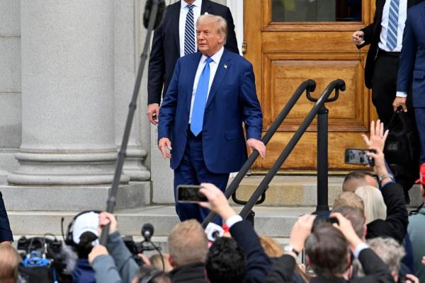 Former US President and 2024 Republican presidential hopeful Donald Trump (C) departs after filing for New Hampshire's Republican Presidential Primary at the New Hampshire State House, in Concord, New Hampshire, October 23, 2023. Former President Donald Trump signed up for the New Hampshire presidential primary on October 23, 2023, becoming the first person who has served as president to file such paperwork in person more than once.