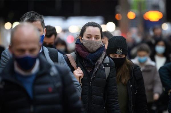 Crowd walking while wearing masks