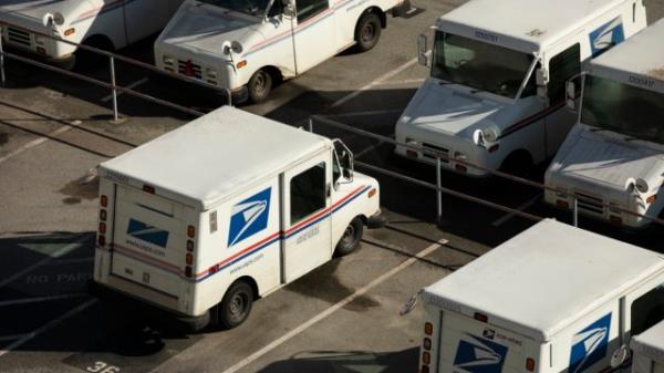 A USPS (United States Postal Service) mail truck parks for the evening.
